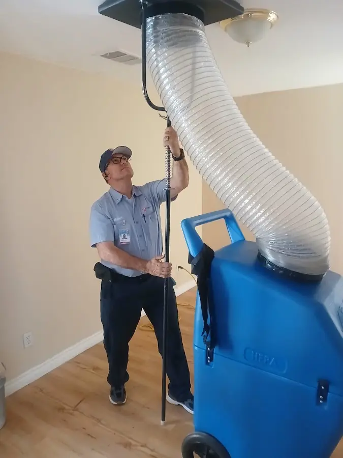 Furnace Tune-Up technician using HEPA equipment in Pecan Grove